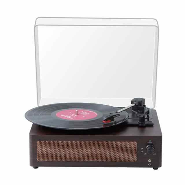 Vintage-style Bluetooth record player with built-in speaker, dark wood-effect finish, clear dust cover, and a vinyl record on the turntable.